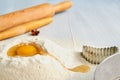 Baking ingredients for dough on the gray table with free copy space: rolling pin, anise stars and bakewares. Baking background