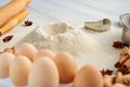 Baking ingredients for dough on the gray table: rolling pin, eggs, ginger, anise stars, cinnamon and bakewares. Baking background