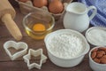 Baking ingredients flour, egg, milk, almonds, sugar on wooden ta