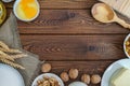 Baking ingredients - flour, sugar, egg, butter on vintage wood table. Top view. Royalty Free Stock Photo