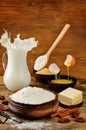 Baking ingredients: milk, eggs, sugar, butter with flying parts