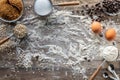 Baking ingredients scattered around on a rustic wooden table. Royalty Free Stock Photo