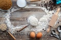 Baking ingredients scattered around on a rustic wooden table. Royalty Free Stock Photo