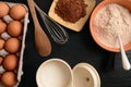 Baking ingredients on a stone table: eggs, flour, sugar and cacao Royalty Free Stock Photo