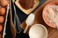 Baking ingredients on a stone table: eggs, flour, sugar and cacao