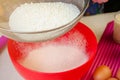 Baking Ingredients and Utensils for Cooking Sponge Cake. Process Cooking Sponge Cake. Woman Sifts the Flour Through a Sieve