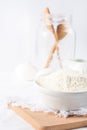 Baking ingredients. White background. Ingredients and tools to make a cake. Flour, milk, eggs, rolling pin, wooden spoons, jar. Royalty Free Stock Photo