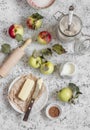 Baking ingredients - whole wheat flour, apples, butter, sugar, cinnamon. On a wooden table Royalty Free Stock Photo