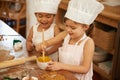 Baking is so much fun. Two little girls having fun while baking in the kitchen. Royalty Free Stock Photo