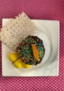 Baking muffin in chocolate glaze, with an orange slice, on a pink background