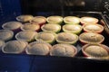 Baking muffins in oven, selective focus