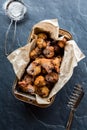 A baking pan lined with parchment paper filled with deep fried fritters. Royalty Free Stock Photo