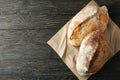 Baking paper with fresh bread on wooden table Royalty Free Stock Photo