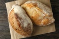 Baking paper with fresh bread on wooden table Royalty Free Stock Photo