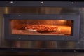 Baking pizza in electric oven Royalty Free Stock Photo