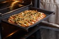 Baking pizza in oven. Royalty Free Stock Photo