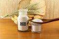 Baking powder in a glass jar and wooden spoon with cookie and bread Royalty Free Stock Photo