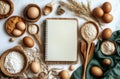 Baking prep with eggs and flour on a rustic table, featuring a blank notebook and tools