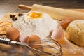 Baking preparation: eggs, flour, rolling pin, spices on a board