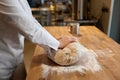 Baking process, closeup baker hands kneading dough on table