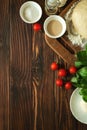Baking in rural kitchen. Dough and ingredients for baking pizza on vintage brown wooden table. Top view. Rustic background Royalty Free Stock Photo