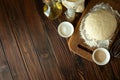 Baking in rural kitchen. Dough and recipe ingredients on vintage brown wooden table. Top view. Rustic background Royalty Free Stock Photo