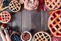 Baking scene frame with an assortment of homemade fruit pies over a wood