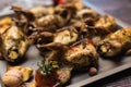 A baking sheet with fried baked quails in a rustic style. Royalty Free Stock Photo
