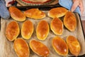 On the baking sheet are ready-made Russian pies with filling. Homemade baking Royalty Free Stock Photo