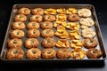 baking sheet with unbaked bagels ready for oven Royalty Free Stock Photo