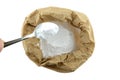 Baking soda in contains in brown paper bag, isolate background