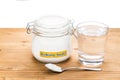 Baking soda in jar, spoonful and glass of water for multiple hol Royalty Free Stock Photo