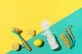 Baking soda, lemon, mustard powder and bamboo brushes against household chemicals products over yellow background. Top Royalty Free Stock Photo