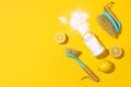 Baking soda, lemon, mustard powder and bamboo brushes against household chemicals products over yellow background. Top Royalty Free Stock Photo