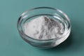 Baking soda, Sodium bicarbonate in glass bowl and spoon on table