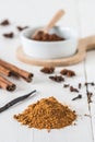 Baking spices like cinnamon, star anise, cocoa and vanilla bean on white wooden table Royalty Free Stock Photo