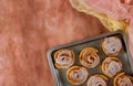 Baking steel tray with cinnamon rolls on table Royalty Free Stock Photo
