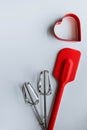 Baking supplies on white. Spatula, mixer whisks, cookie cutter on white background Royalty Free Stock Photo