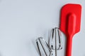 red spatula, mixer whisks on white background