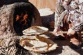 Baking traditional bread in a natural clay oven.