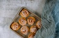 Baking tray with cinnamon buns on white table Royalty Free Stock Photo