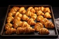 a baking tray full of unbaked dough in the shape of croissants