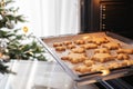 Baking tray with ginger Christmas cookies snowflakes in the oven