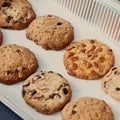 Close-up of homemade peanut biscuits with chocolate chunks for dieting vegan eat on a baking sheet. Royalty Free Stock Photo