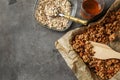 Baking tray with tasty granola and oatmeal on grey table