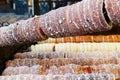 Baking trdelnik pastry on wood fire.