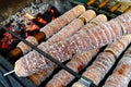 Baking trdelnik pastry on wood fire. Royalty Free Stock Photo