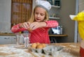 Baking up something delicious in the kitchen. Cropped shot of a little girl baking in the kitchen. Royalty Free Stock Photo