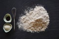 Baking utensils flour and mixer on dark surface
