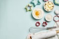 Baking utensils and ingredients. Rolling pin, sugar sprinkling, whisk with cookie mold on a blue background. Baking concept.